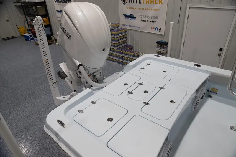 Slide: The Image of 2024 Contender 26 Bay boat with Yamaha outboard motor in showroom. - 6