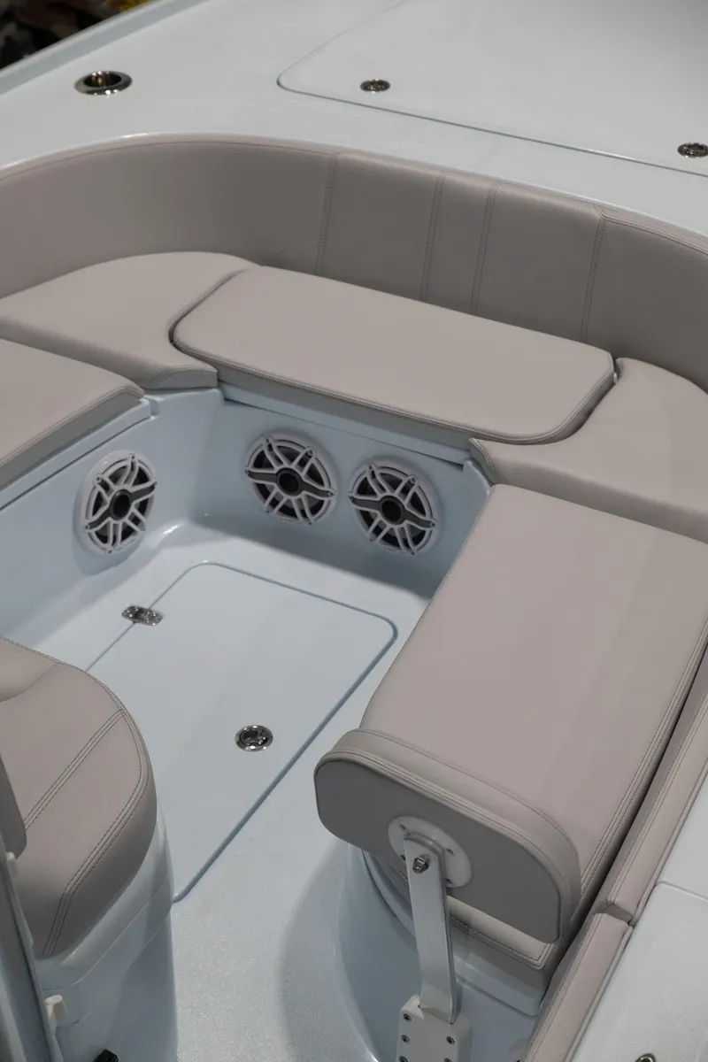 Slide: The Image of 2024 Contender 26 Bay boat interior with cushioned seating and built-in speakers. - 8