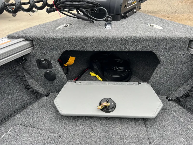 Slide: The Image of Lund 1975 Tyee 2025 boat interior storage compartment with wiring and accessories. - 10