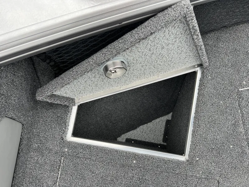Slide: The Image of Open storage compartment in 2025 Lund 1975 Tyee boat, featuring carpeted interior. - 12