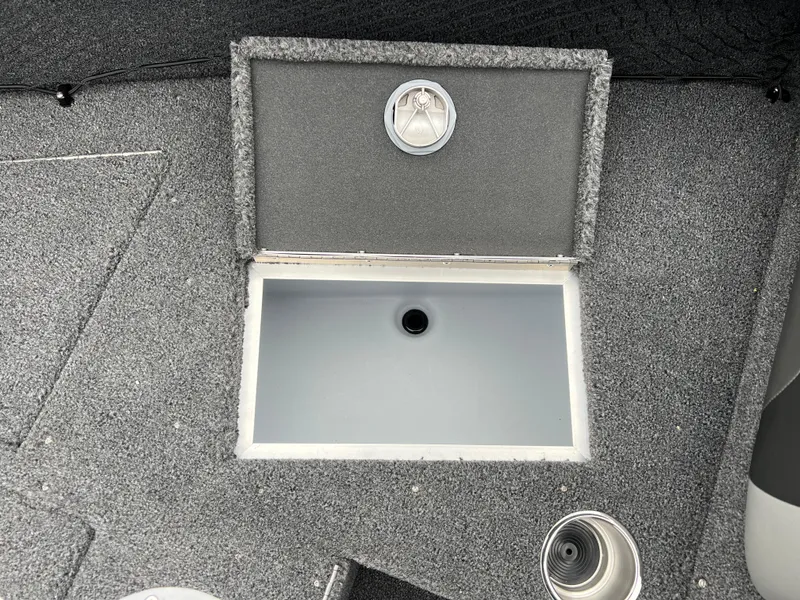 Slide: The Image of Open storage compartment on 2025 Lund 1975 Tyee boat deck. - 13