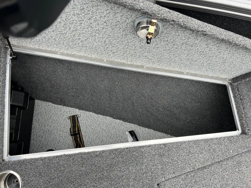 Slide: The Image of Open storage compartment in 2025 Lund 1975 Tyee boat, featuring carpeted interior. - 14