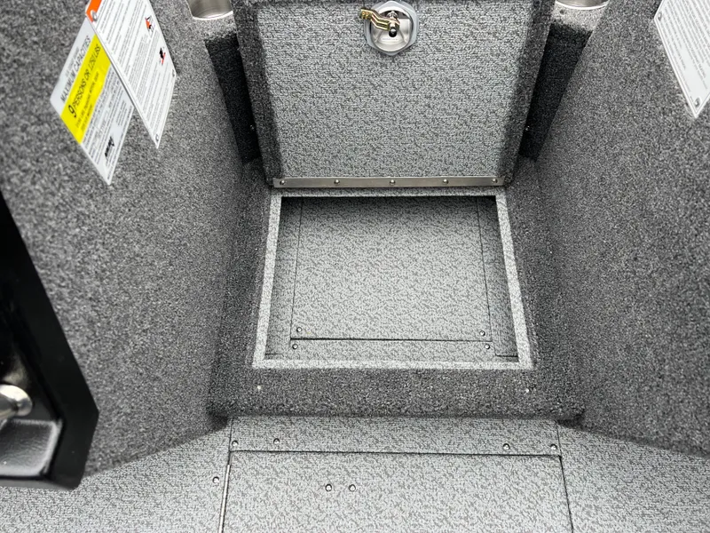 Slide: The Image of Interior of 2025 Lund 1975 Tyee boat with storage compartment and safety labels. - 16