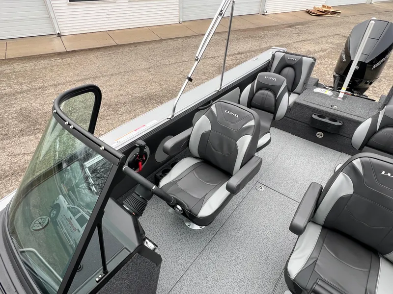Slide: The Image of 2025 Lund 1975 Tyee boat interior with modern seating and steering wheel. - 18
