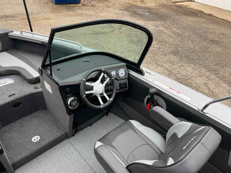 Slide: The Image of 2025 Lund 1975 Tyee boat interior with steering wheel and seating. - 19