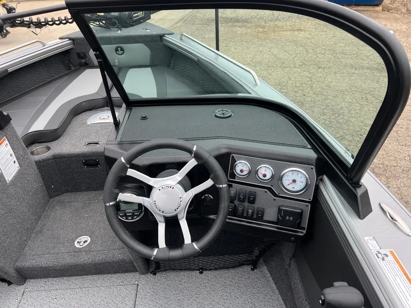 Slide: The Image of 2025 Lund 1975 Tyee boat interior with steering wheel and dashboard controls. - 20