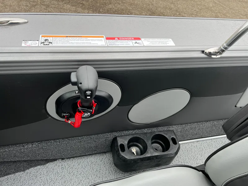 Slide: The Image of 2025 Lund 1975 Tyee boat interior with control panel and cup holders. - 24