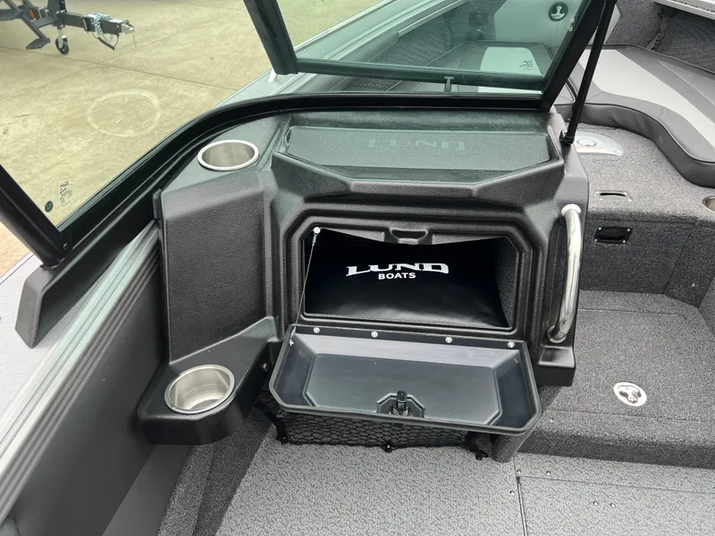 Slide: The Image of 2025 Lund 1975 Tyee boat interior with storage compartment and cup holders. - 28