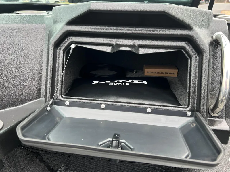Slide: The Image of Open glove compartment in 2025 Lund 1975 Tyee boat, showing storage space. - 29