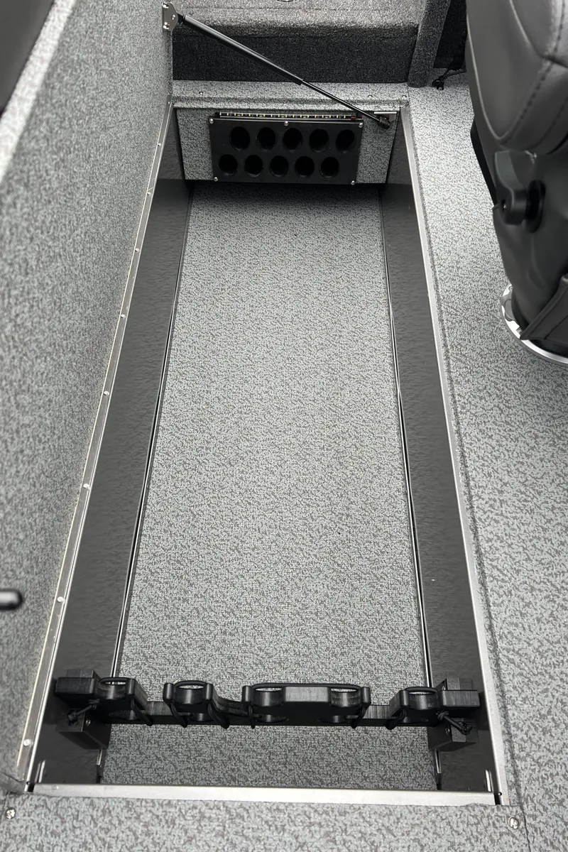 Slide: The Image of 2025 Lund 1975 Tyee boat storage compartment with rod holders. - 30