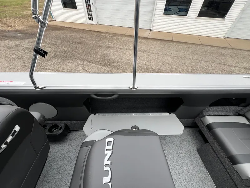 Slide: The Image of Interior of 2025 Lund 1975 Tyee boat with gray seating and storage compartments. - 32