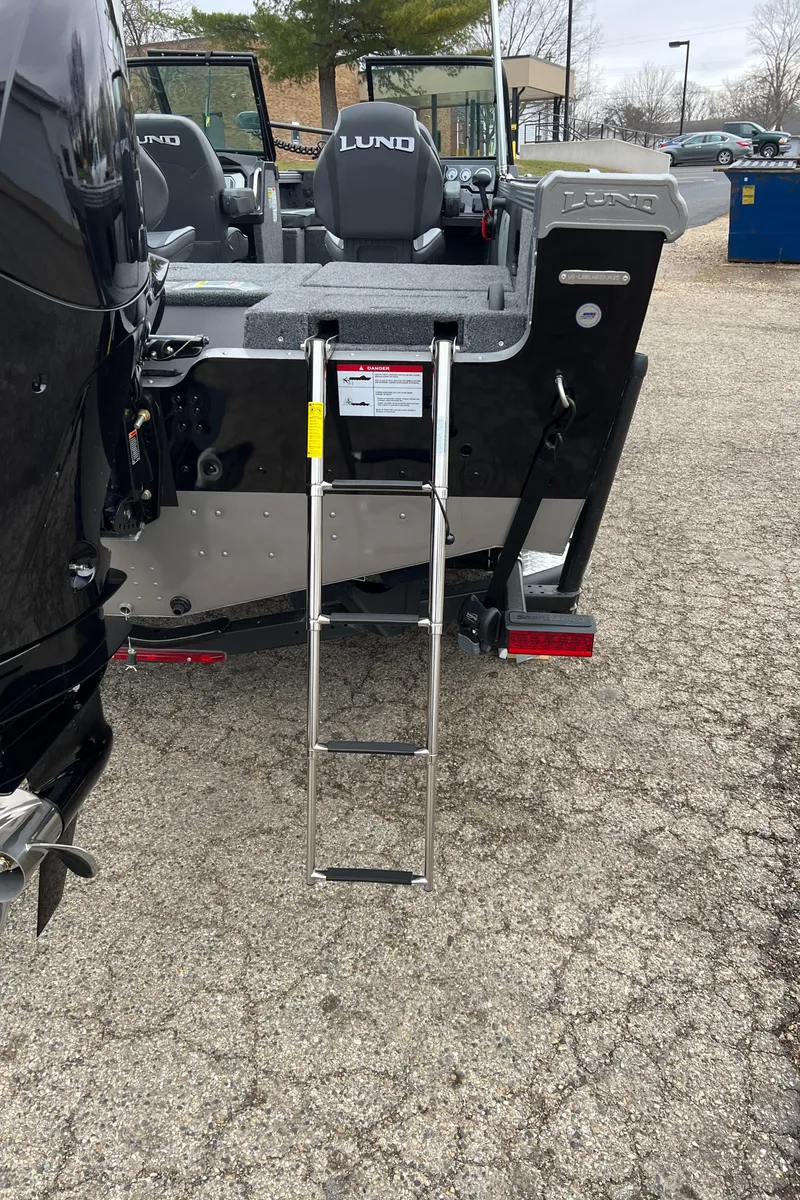 Slide: The Image of 2025 Lund 1975 Tyee boat with ladder on a paved surface. - 6