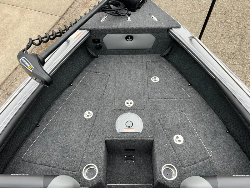 Slide: The Image of 2025 Lund 1975 Tyee boat interior with carpeted deck and storage compartments. - 9