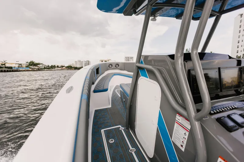 Slide: The Image of AMP 333 boat interior, 2021 model, on water with modern dashboard and seating. - 10