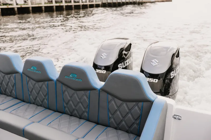 Slide: The Image of AMP 333 boat with Suzuki engines, featuring stylish seating, on the water. - 11