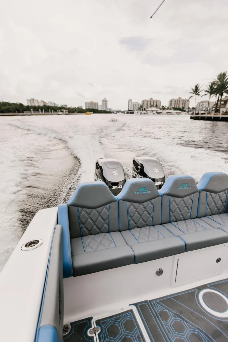Slide: The Image of AMP 333 boat cruising on water, showcasing luxurious seating and dual engines. - 13
