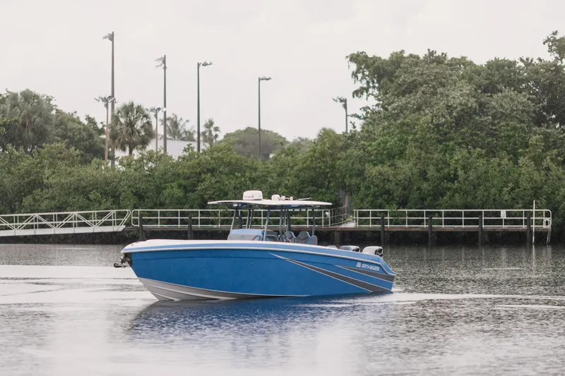 Slide: The Image of Blue AMP 333 boat from 2021 on a calm river near lush greenery. - 16