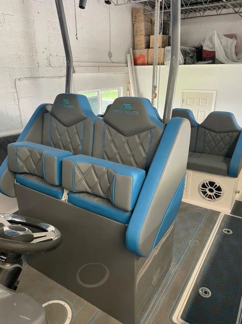 Slide: The Image of AMP 333 boat interior, 2021 model, featuring blue and gray cushioned seats. - 18