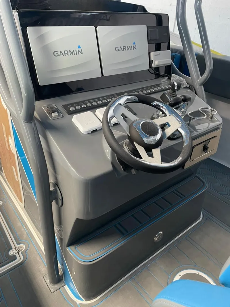 Slide: The Image of AMP 333 boat console with Garmin displays and steering wheel, 2021 model. - 20