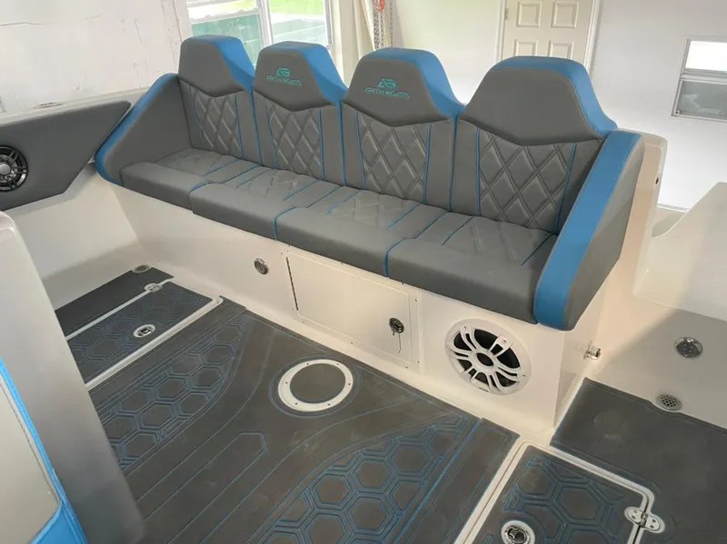 Slide: The Image of Luxury seating in 2021 AMP 333 boat with blue and gray upholstery. - 23