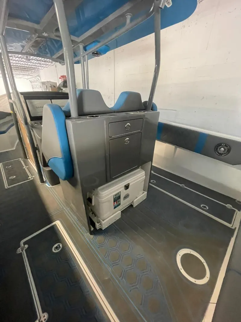 Slide: The Image of Interior of 2021 AMP 333 boat with blue seating and storage compartments. - 24