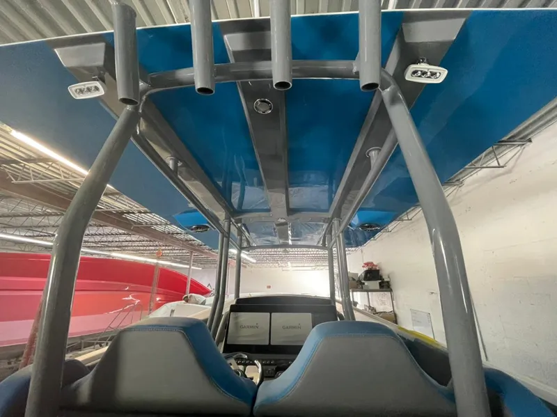 Slide: The Image of Interior view of AMP 333 boat, featuring blue canopy and dual seats, 2021 model. - 25