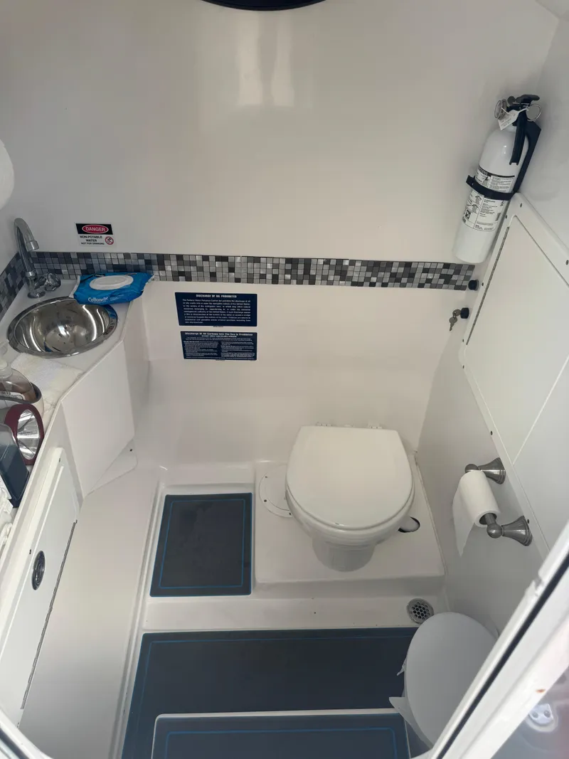 Slide: The Image of Compact boat bathroom with toilet, sink, and fire extinguisher, AMP 333 model, 2021. - 27