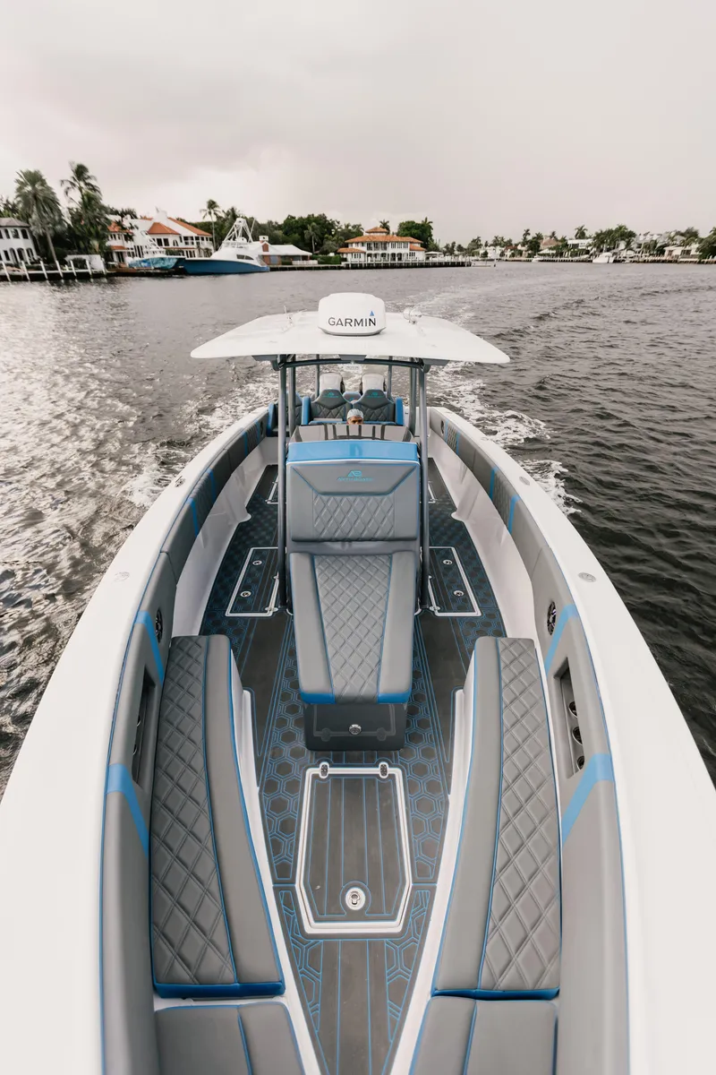 Slide: The Image of AMP 333 boat cruising on a calm waterway, showcasing sleek design and modern features. - 9