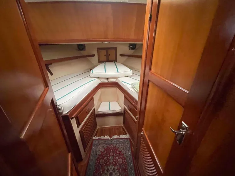 Slide: The Image of Cozy cabin interior of 1987 Hartman-Palmer 38 yacht with wooden finish and striped bedding. - 22