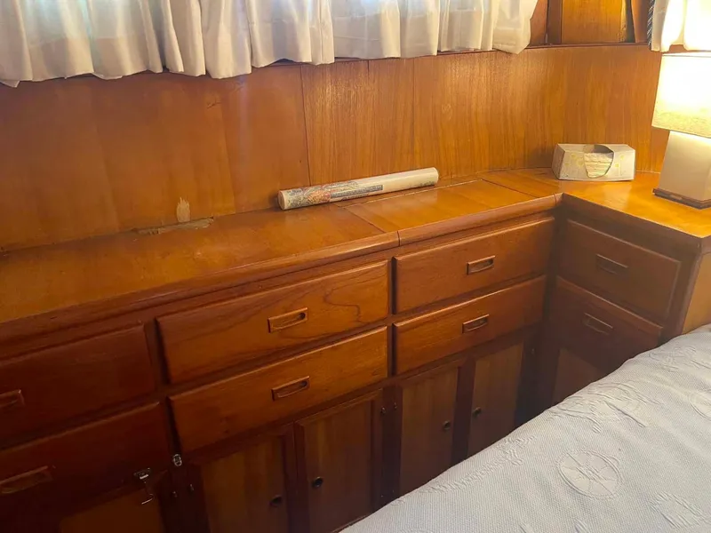 Slide: The Image of Wooden cabinetry in a 1987 Hartman-Palmer 38 boat interior, with lamp and radio. - 28