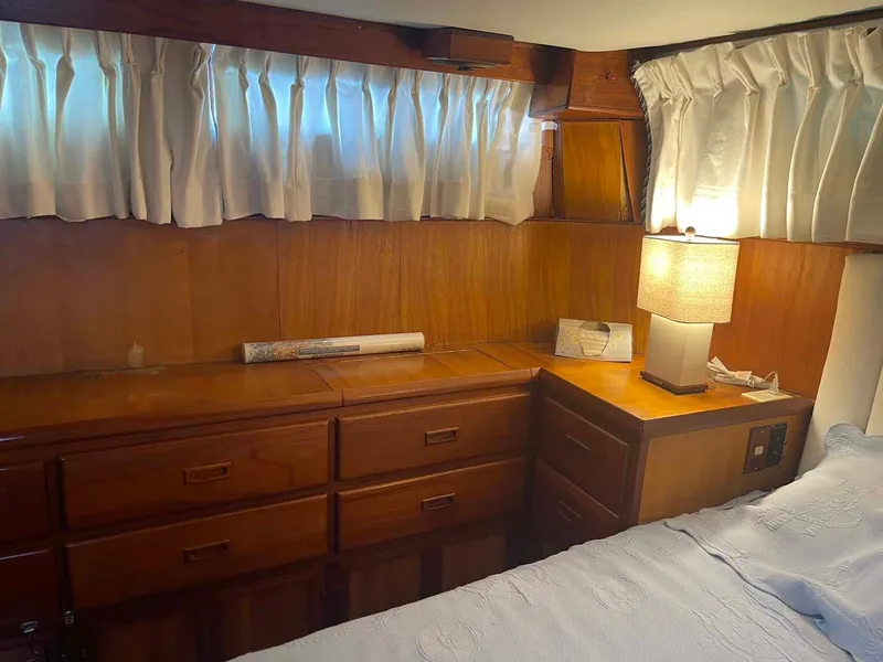Slide: The Image of Cozy 1987 Hartman-Palmer 38 yacht cabin with wooden drawers and soft lighting. - 29