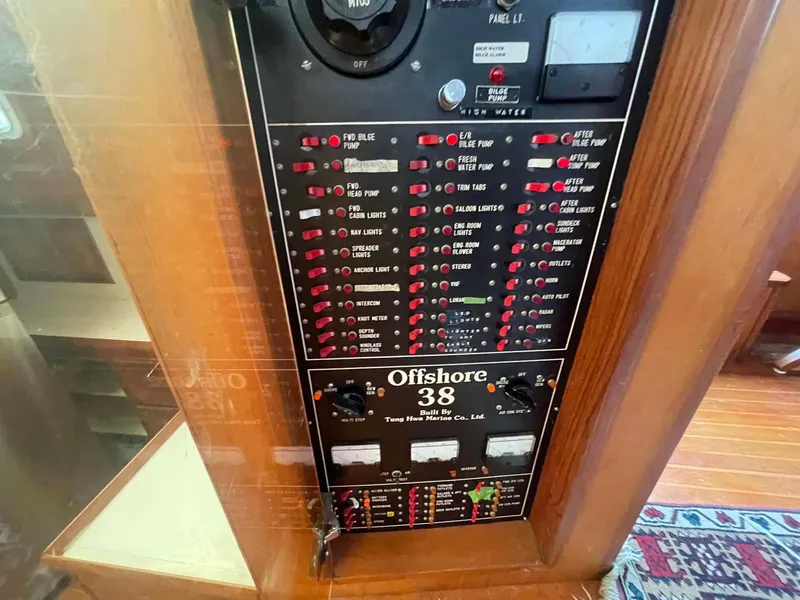 Slide: The Image of Electrical panel of 1987 Hartman-Palmer Offshore 38 boat, featuring various switches and controls. - 33