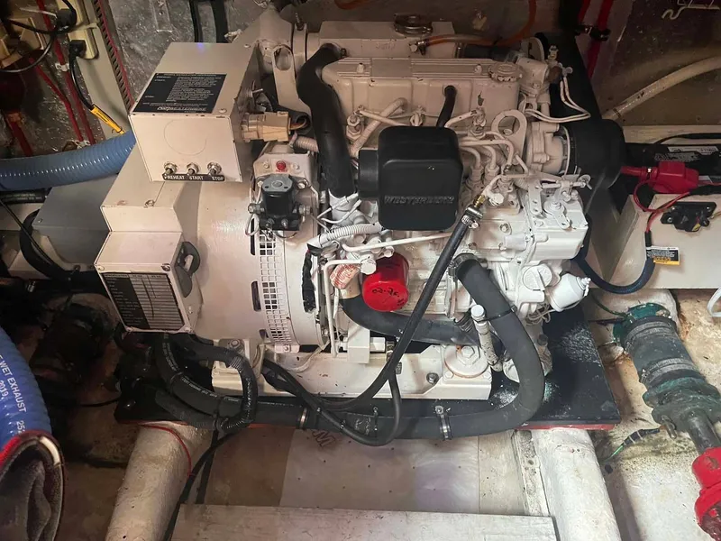 Slide: The Image of 1987 Hartman-Palmer 38 engine in a boat's engine room, featuring hoses and wiring. - 46
