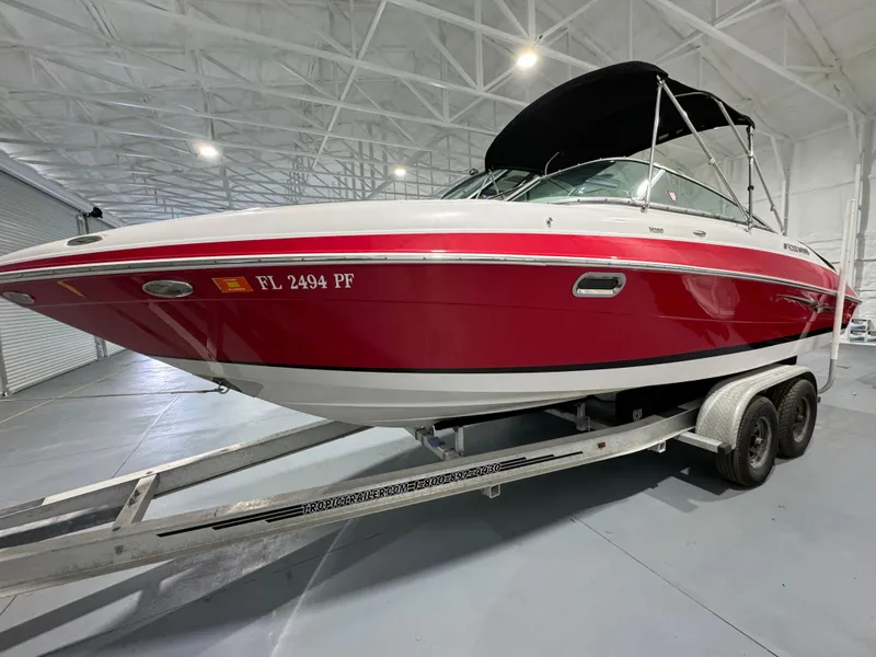 The Image of 2012 Four Winns H260 boat on trailer in indoor storage facility. - 0