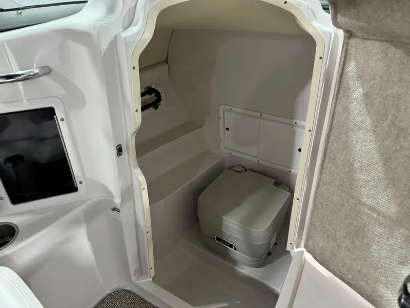 Slide: The Image of 2012 Four Winns H260 boat interior with compact marine toilet. - 14