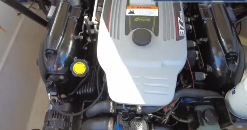 Slide: The Image of 2012 Four Winns H260 engine compartment, showcasing a well-maintained motor. - 19