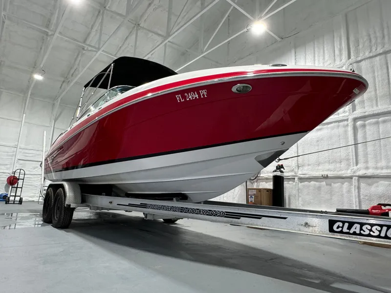 Slide: The Image of 2012 Four Winns H260 boat on trailer in indoor storage. - 6