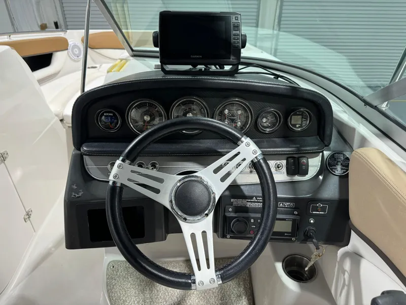 Slide: The Image of 2012 Four Winns H260 boat dashboard with steering wheel and navigation system. - 7