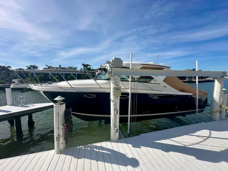 Slide: The Image of 2012 Tiara Yachts 3100 Coronet docked under clear blue sky. - 0