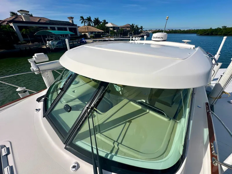 Slide: The Image of 2012 Tiara Yachts 3100 Coronet boat docked by waterfront homes. - 11