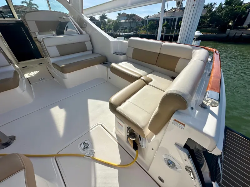 Slide: The Image of 2012 Tiara Yachts 3100 Coronet interior with beige seating and waterfront view. - 13