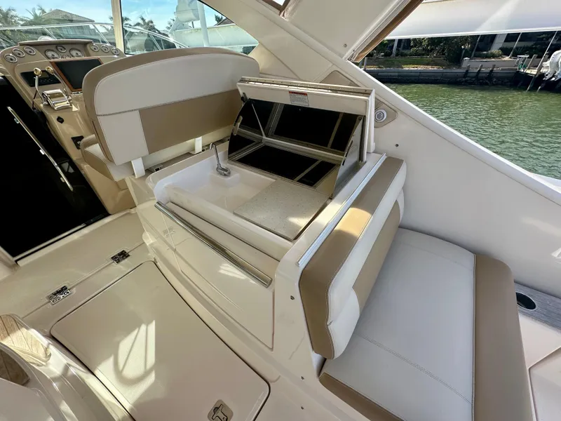 Slide: The Image of 2012 Tiara Yachts 3100 Coronet interior with seating and helm, docked by the water. - 14