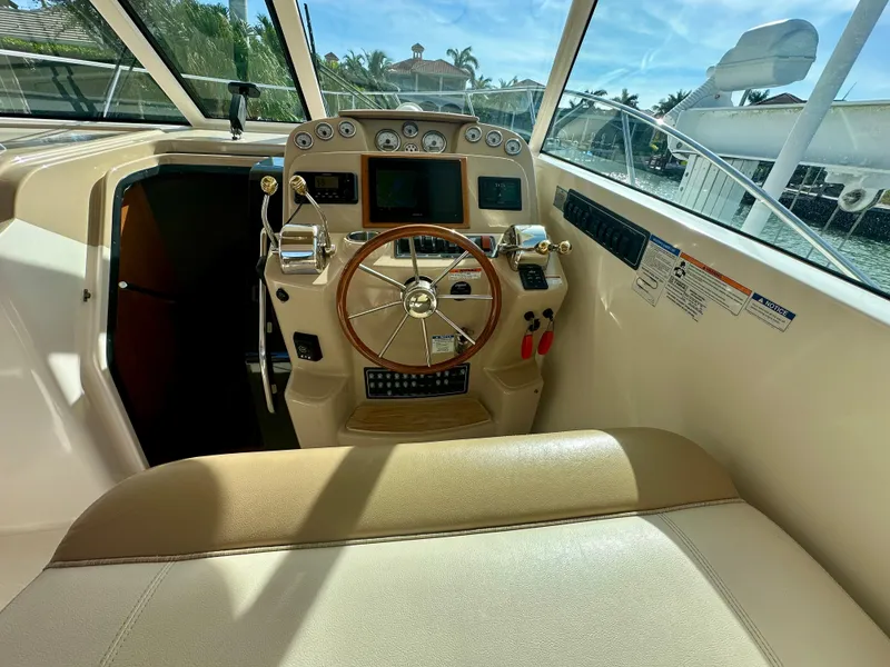 Slide: The Image of 2012 Tiara Yachts 3100 Coronet helm with steering wheel and control panel. - 15