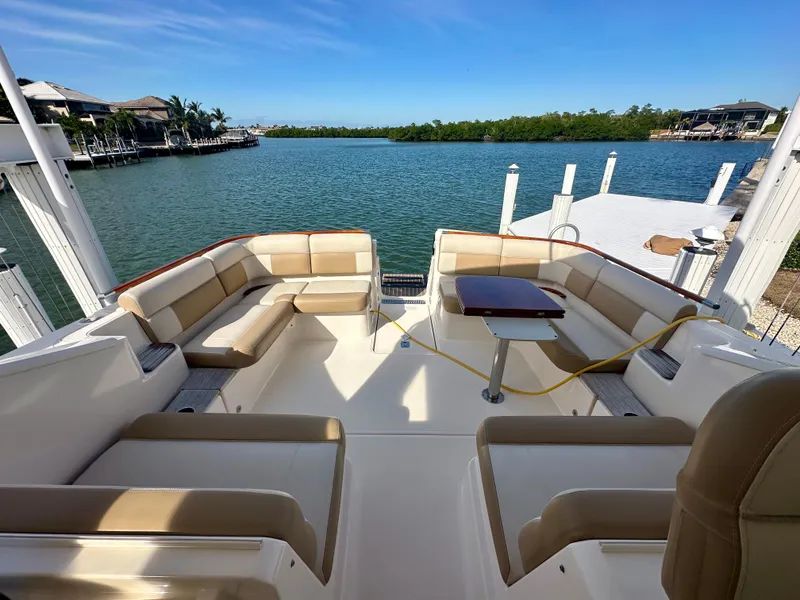 Slide: The Image of 2012 Tiara Yachts 3100 Coronet with spacious seating, docked by serene waterfront. - 18