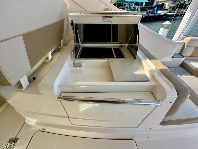 Slide: The Image of 2012 Tiara Yachts 3100 Coronet boat interior with kitchenette and seating area. - 19