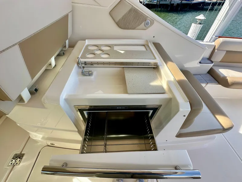 Slide: The Image of Tiara Yachts 3100 Coronet 2012, onboard kitchenette with open grill and seating area. - 21
