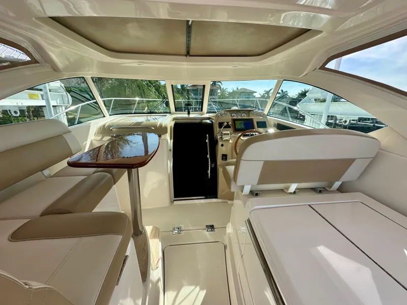 Slide: The Image of Interior of 2012 Tiara Yachts 3100 Coronet, featuring elegant seating and navigation area. - 22