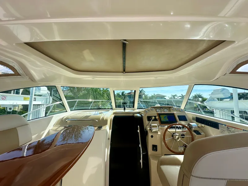 Slide: The Image of Interior of 2012 Tiara Yachts 3100 Coronet, featuring helm and seating area. - 23