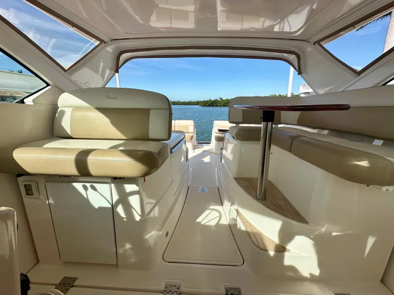 Slide: The Image of Interior of 2012 Tiara Yachts 3100 Coronet with beige seating and open water view. - 29