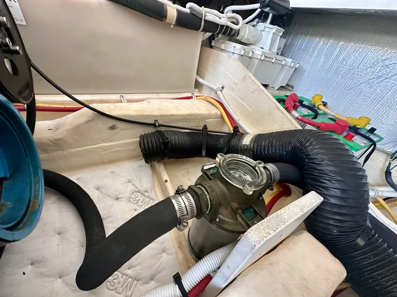 Slide: The Image of Engine compartment of 2012 Tiara Yachts 3100 Coronet with hoses and mechanical components. - 35